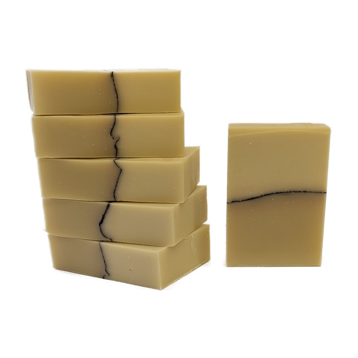A stack of First Light soap bars with one standing beside it