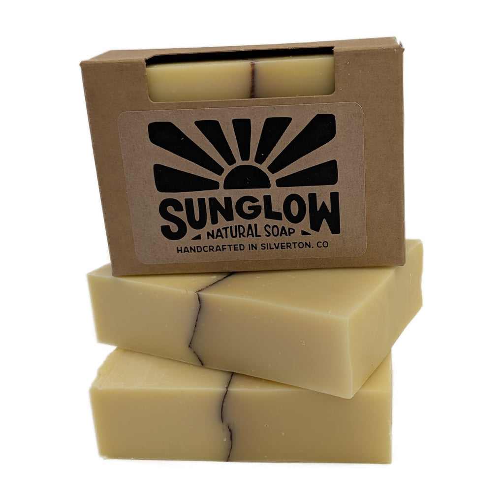 First Light soap bars stacked with their kraft box