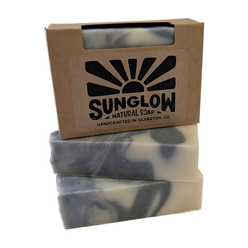 Big Blue Sky soap bars stacked with their kraft box
